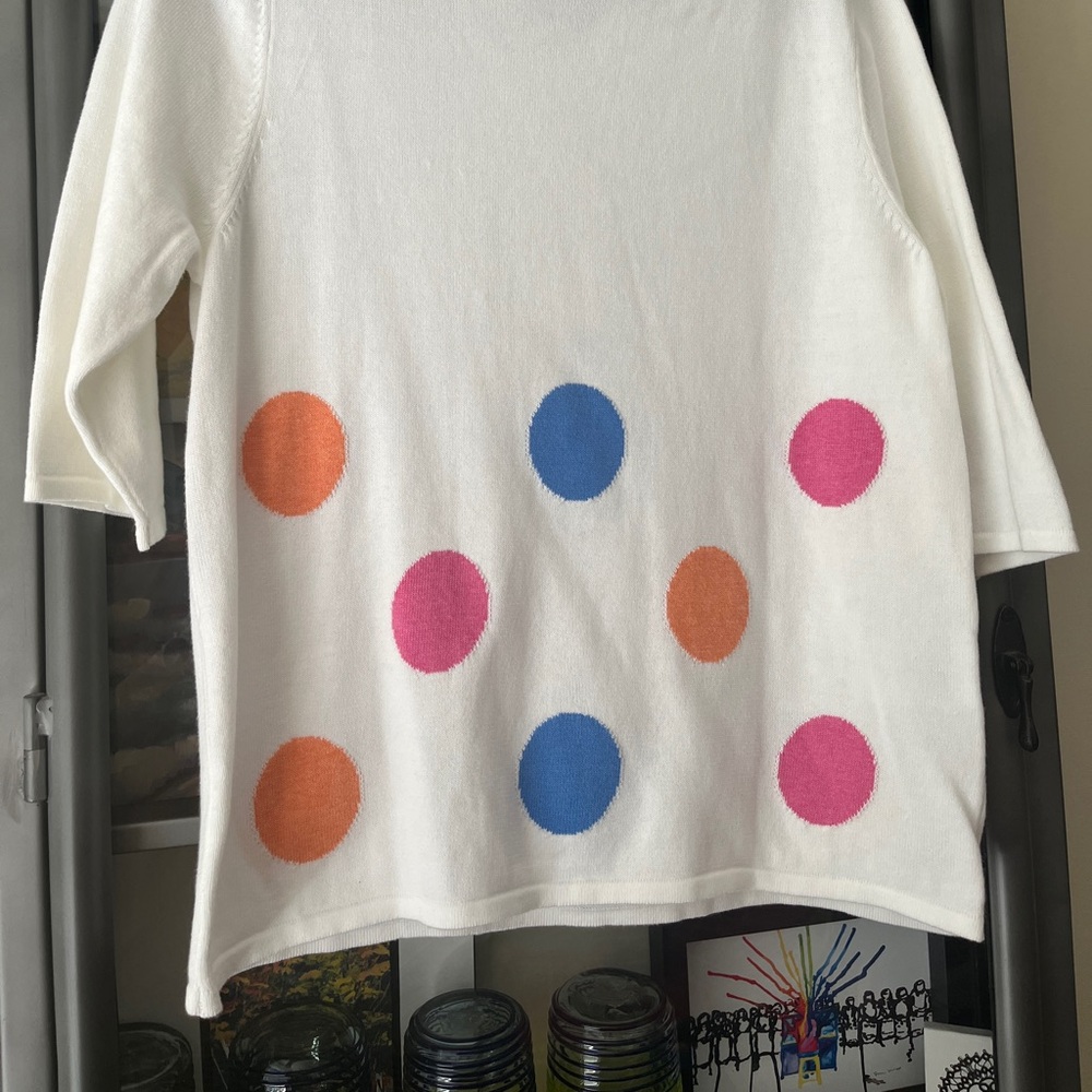Designs by Marble Crafters White knit sweater with polka dots.